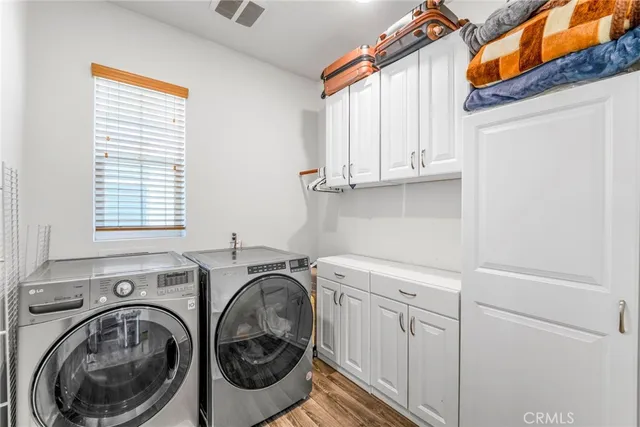 a utility room with sink dryer and washer
