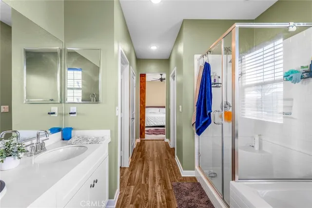 a bathroom with a sink a mirror and a shower