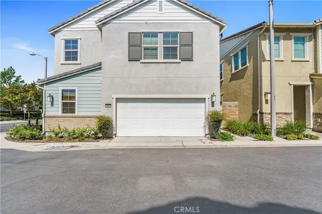 a front view of a house with a yard and a garage