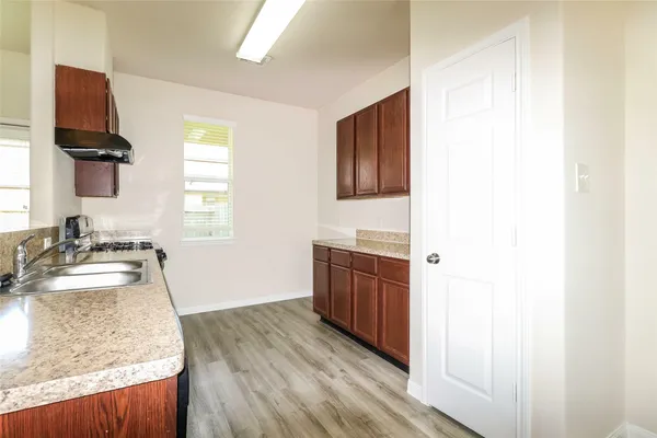 a spacious bathroom with a granite countertop sink and a mirror