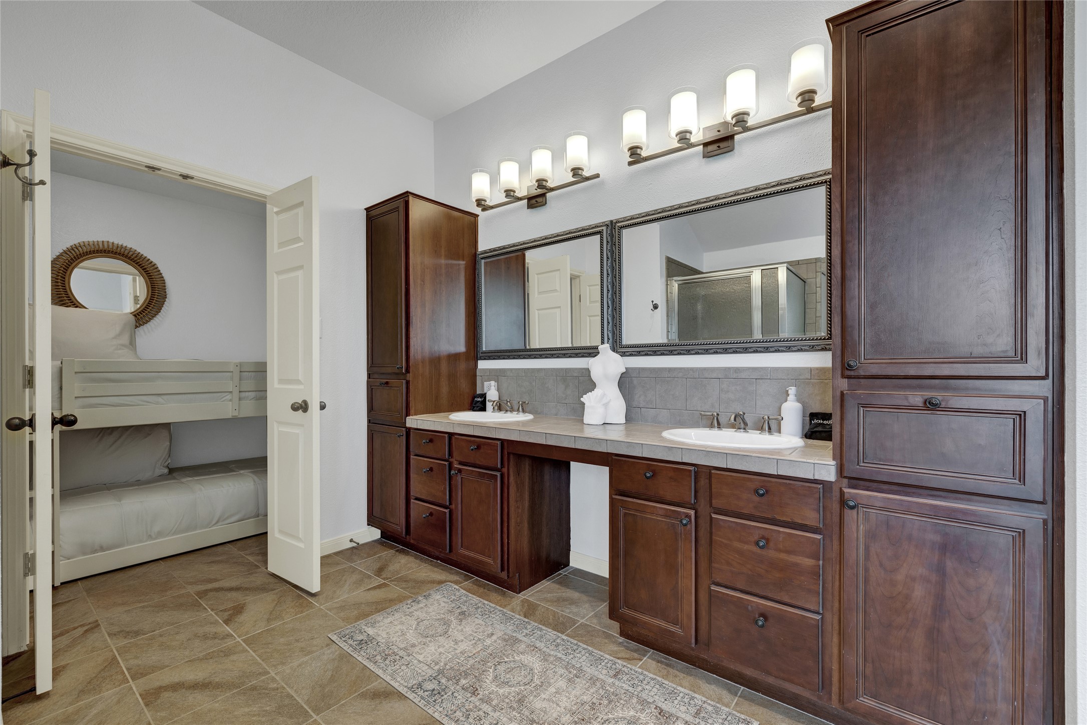 157 Kurt Kramer Road Fredericksburg, TX 78624 - Photo 14 of 38 A large dual vanity hosts a center make-up counter.