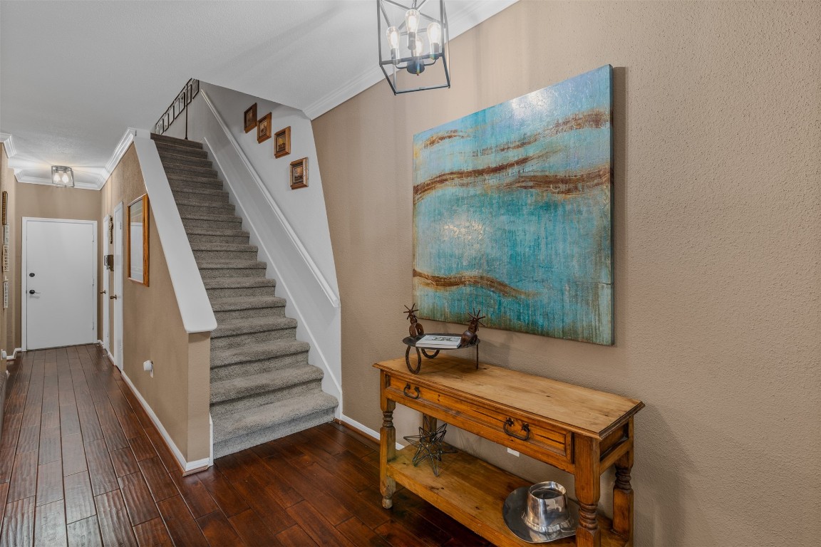 6000 Reims Road, Unit 2307 Houston, TX 77036 - Photo 11 of 26 This entryway features warm wood flooring and neutral walls, with a staircase to the upper level.