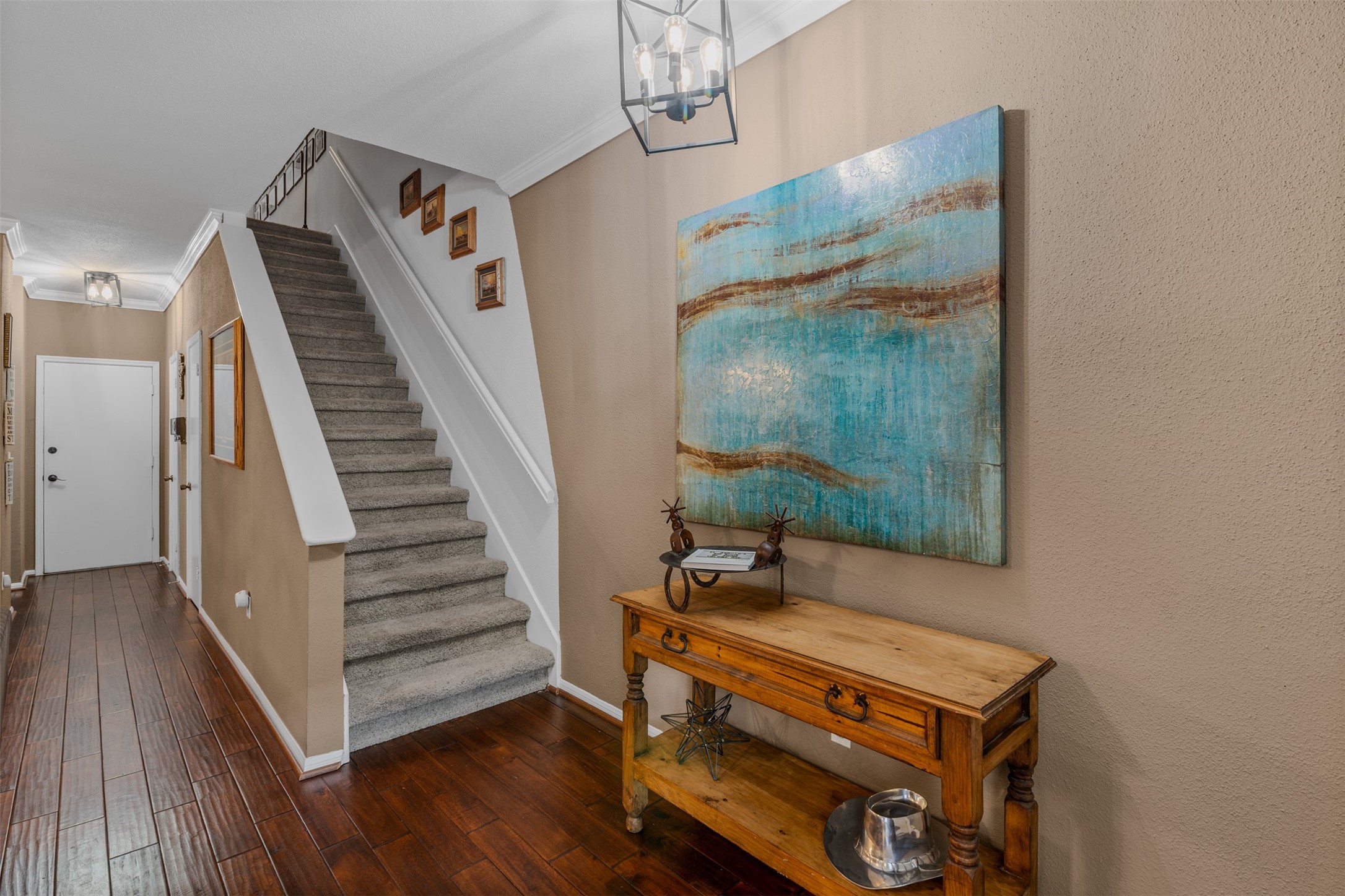 6000 Reims Road, Unit 2307 Houston, TX 77036 - Photo 11 of 26 This entryway features warm wood flooring and neutral walls, with a staircase to the upper level.