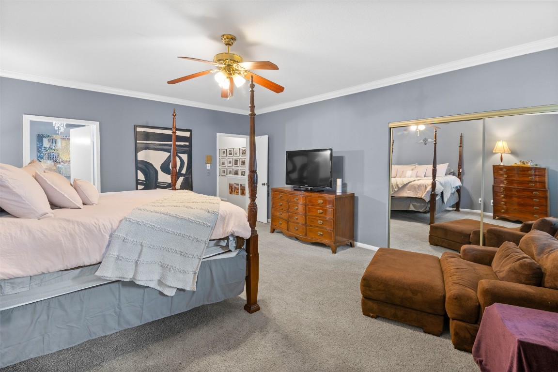 6000 Reims Road, Unit 2307 Houston, TX 77036 - Photo 13 of 26 This spacious bedroom features a seating area and ample storage with mirrored closets. The room is well-lit with a ceiling fan and decorated in calming neutral tones.