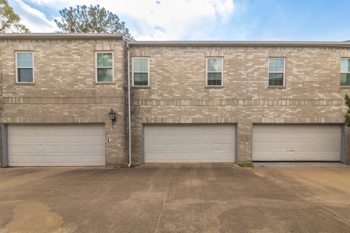 6000 Reims Road, Unit 2307 Houston, TX 77036 - Photo 20 of 26 Each unit features large windows and a double garage, providing ample parking and storage space.