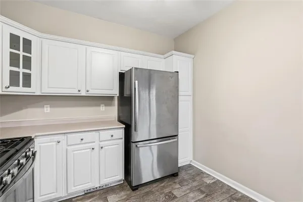 a kitchen with stainless steel appliances a refrigerator and cabinets
