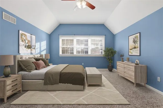 a bedroom with a large bed and a chandelier