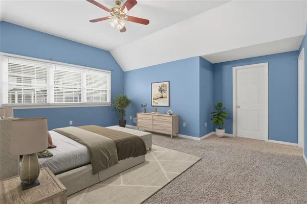 a bedroom with a large bed and a chandelier