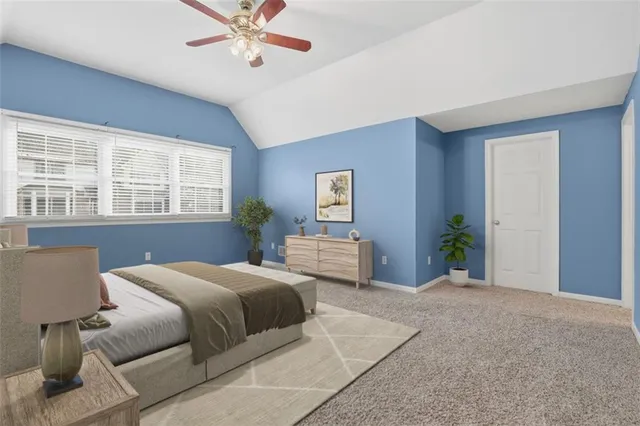a view of an empty room with a ceiling fan