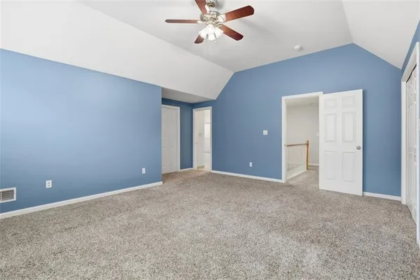 a view of an empty room with a ceiling fan