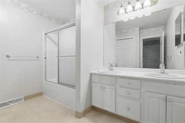 a bathroom with a sink vanity and a mirror