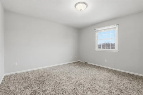 an empty room with a empty space and window
