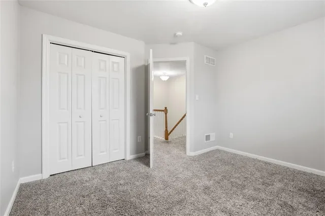 a view of an empty room with a ceiling fan