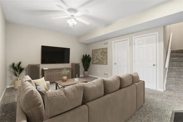 an empty room with a chandelier fan and windows