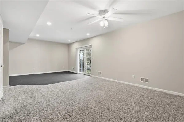 a view of an empty room with a ceiling fan