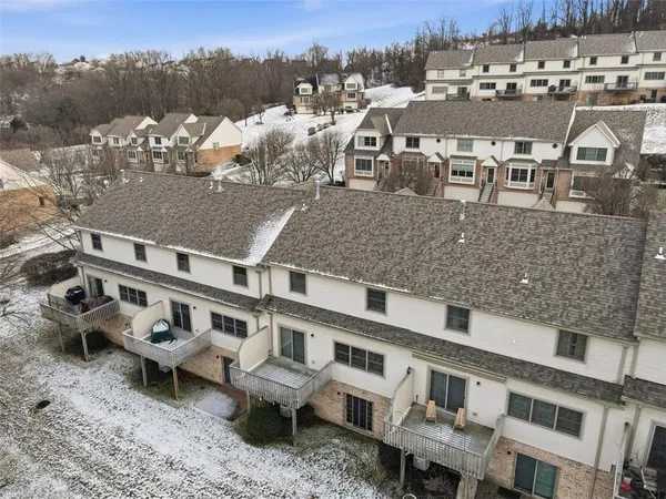 a view of a big house in the middle of a yard