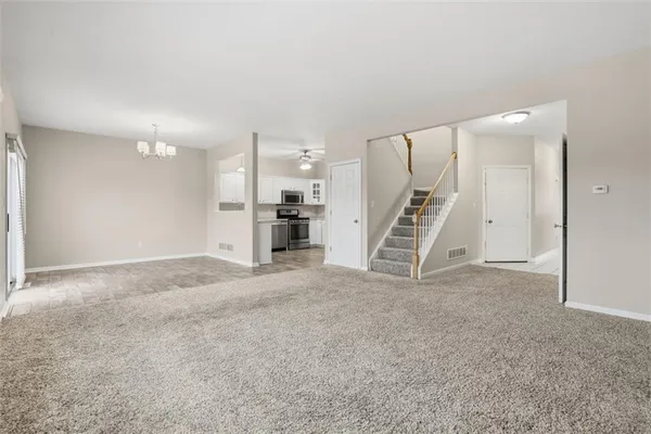 a view of an empty room with a fireplace