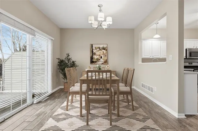 a kitchen with white cabinets stainless steel appliances and sink