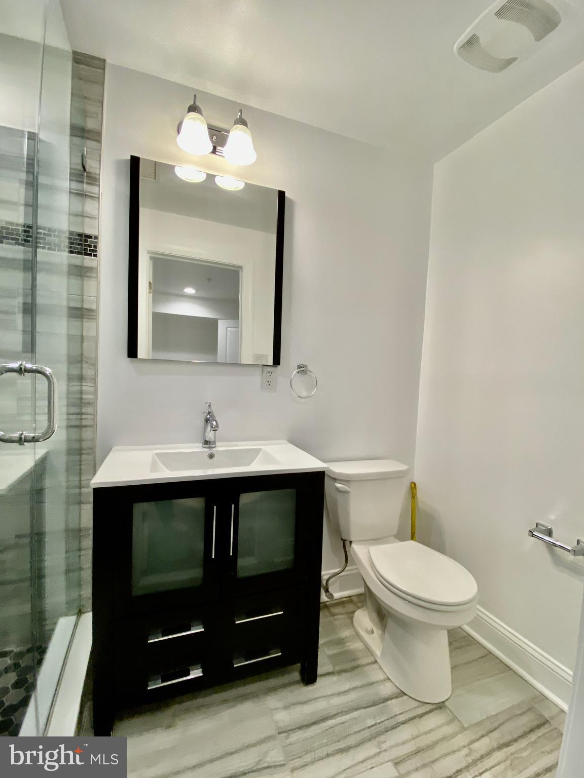 1640 Jackson Street Philadelphia, PA 19145 - Photo 19 of 27 a bathroom with a sink toilet and mirror