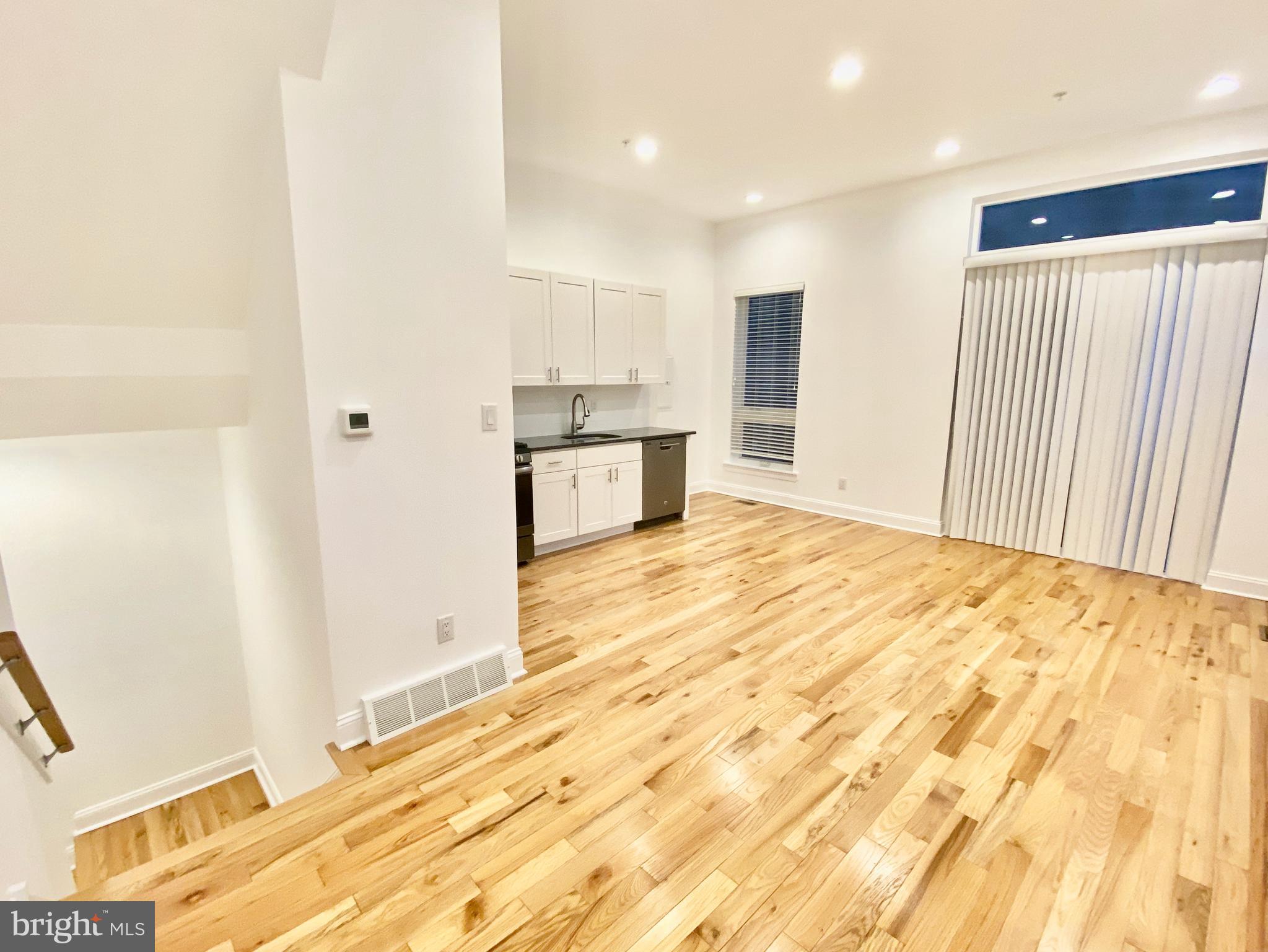 1640 Jackson Street Philadelphia, PA 19145 - Photo 2 of 27 a view of a kitchen with kitchen island and stainless steel appliances