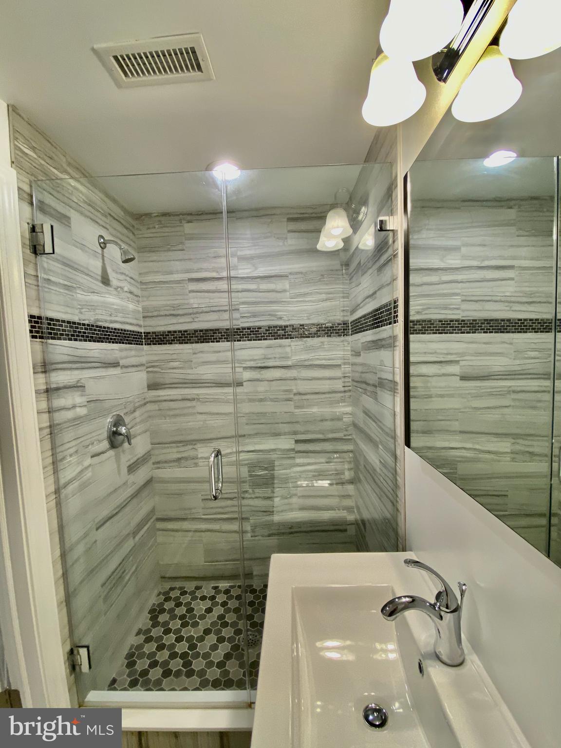 1640 Jackson Street Philadelphia, PA 19145 - Photo 21 of 27 a bathroom with a sink a toilet and shower