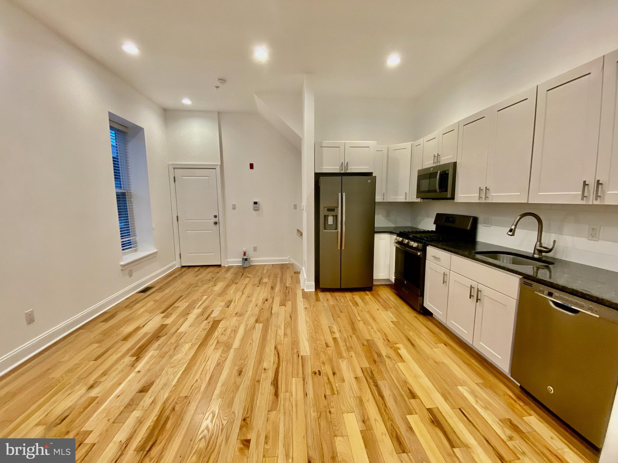 1640 Jackson Street Philadelphia, PA 19145 - Photo 4 of 27 a large kitchen with stainless steel appliances granite countertop a refrigerator and a stove top oven