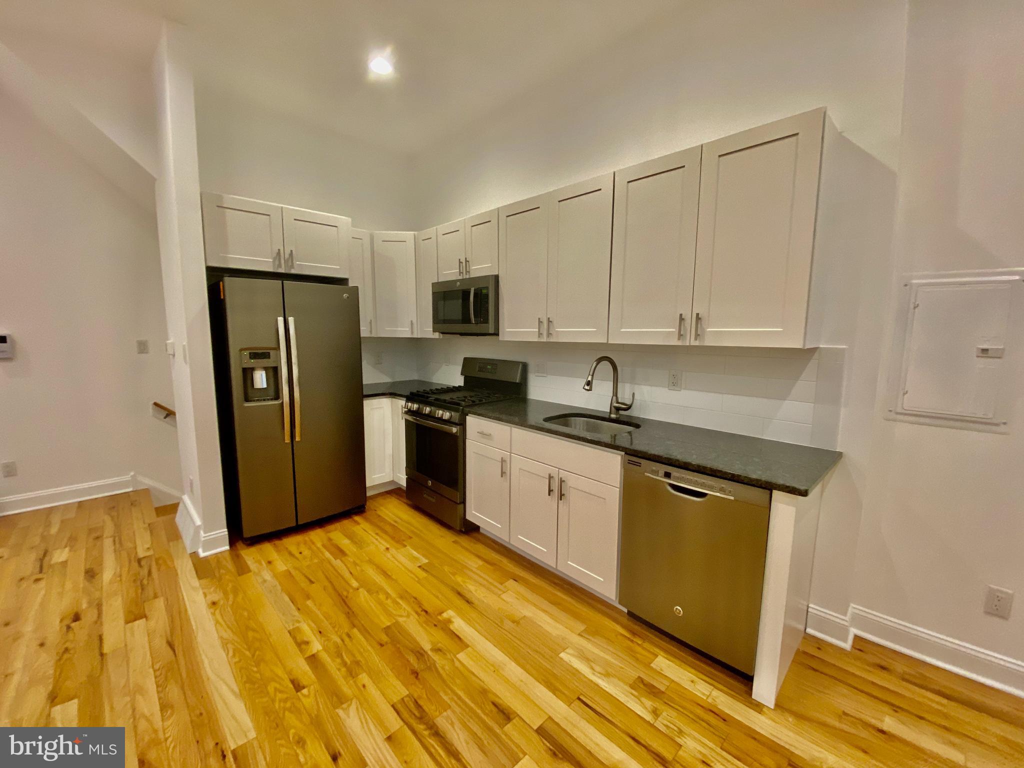 1640 Jackson Street Philadelphia, PA 19145 - Photo 6 of 27 a kitchen with stainless steel appliances granite countertop a refrigerator sink and cabinets