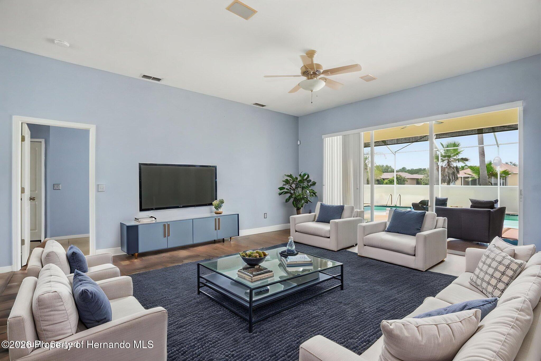 18131 Rivard Boulevard Brooksville, FL 34604 - Photo 10 of 66 a living room with furniture and a flat screen tv