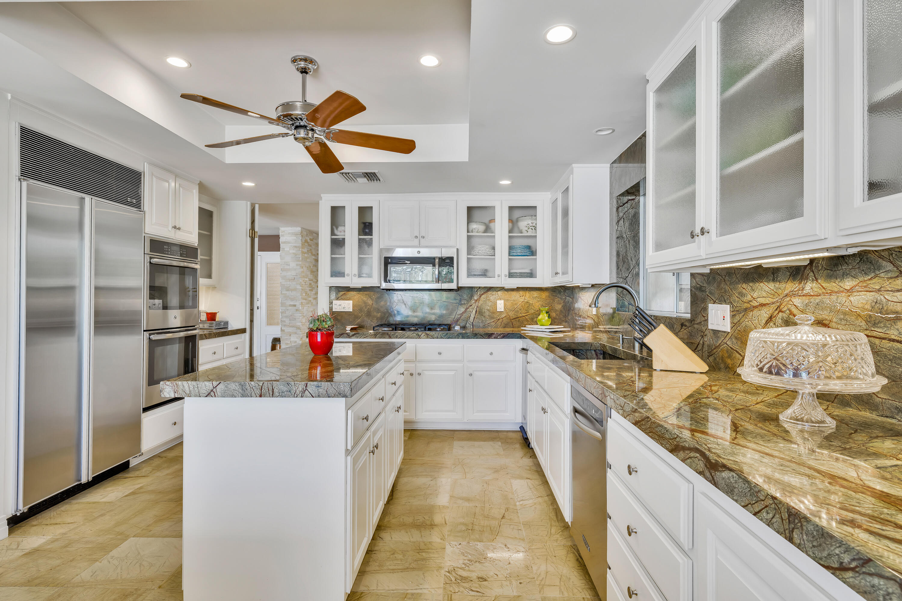 73005 Haystack Road Palm Desert, CA 92260 - Photo 21 of 45 a kitchen with stainless steel appliances granite countertop a sink stove and refrigerator