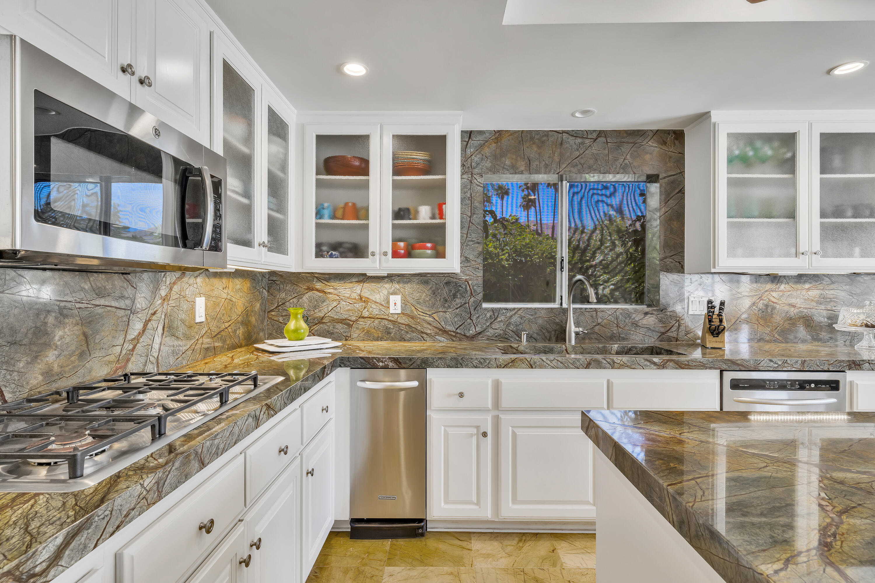 73005 Haystack Road Palm Desert, CA 92260 - Photo 23 of 45 a kitchen with stainless steel appliances granite countertop a stove a sink and a microwave