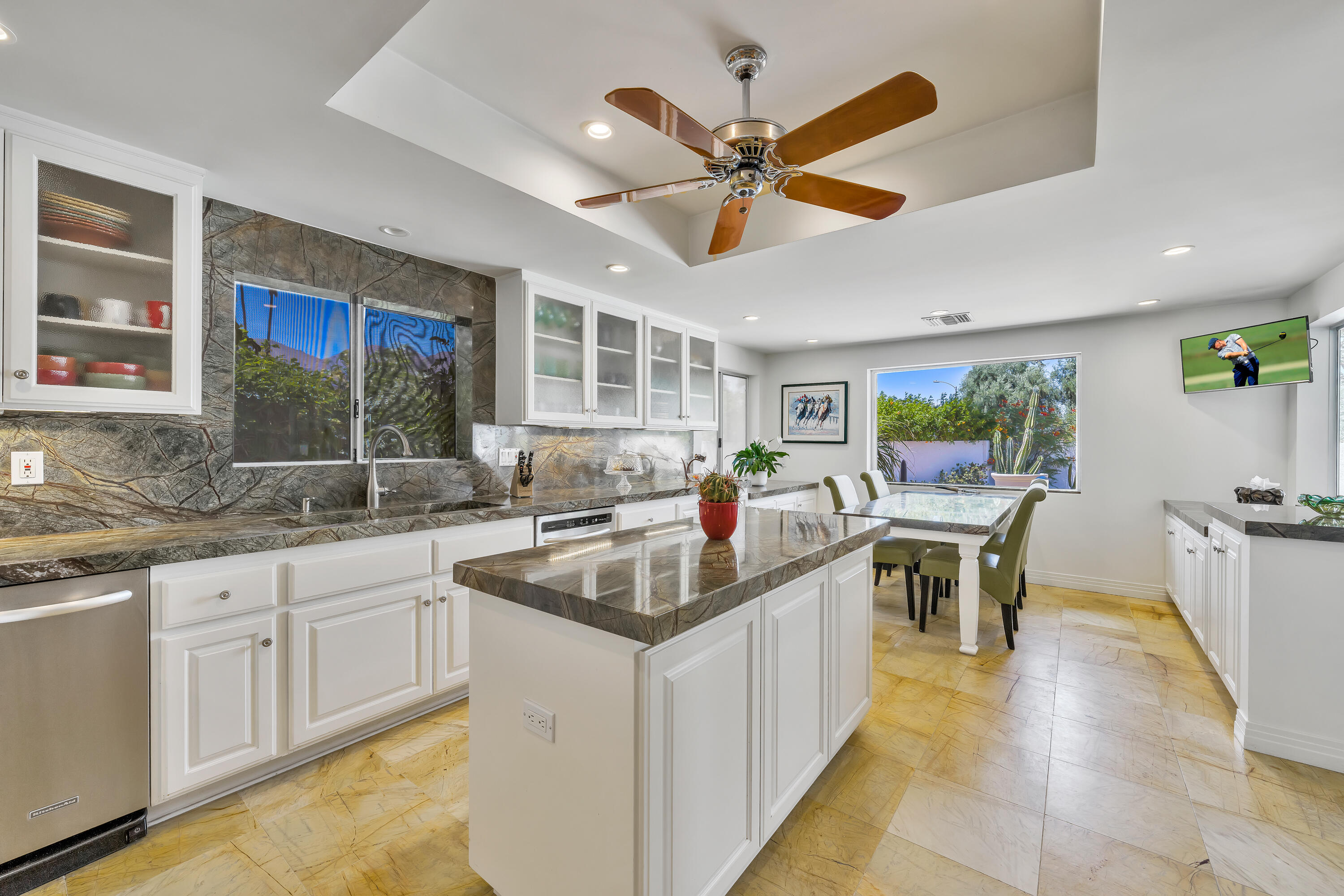 73005 Haystack Road Palm Desert, CA 92260 - Photo 24 of 45 a kitchen with a stove a sink a counter space and dining table