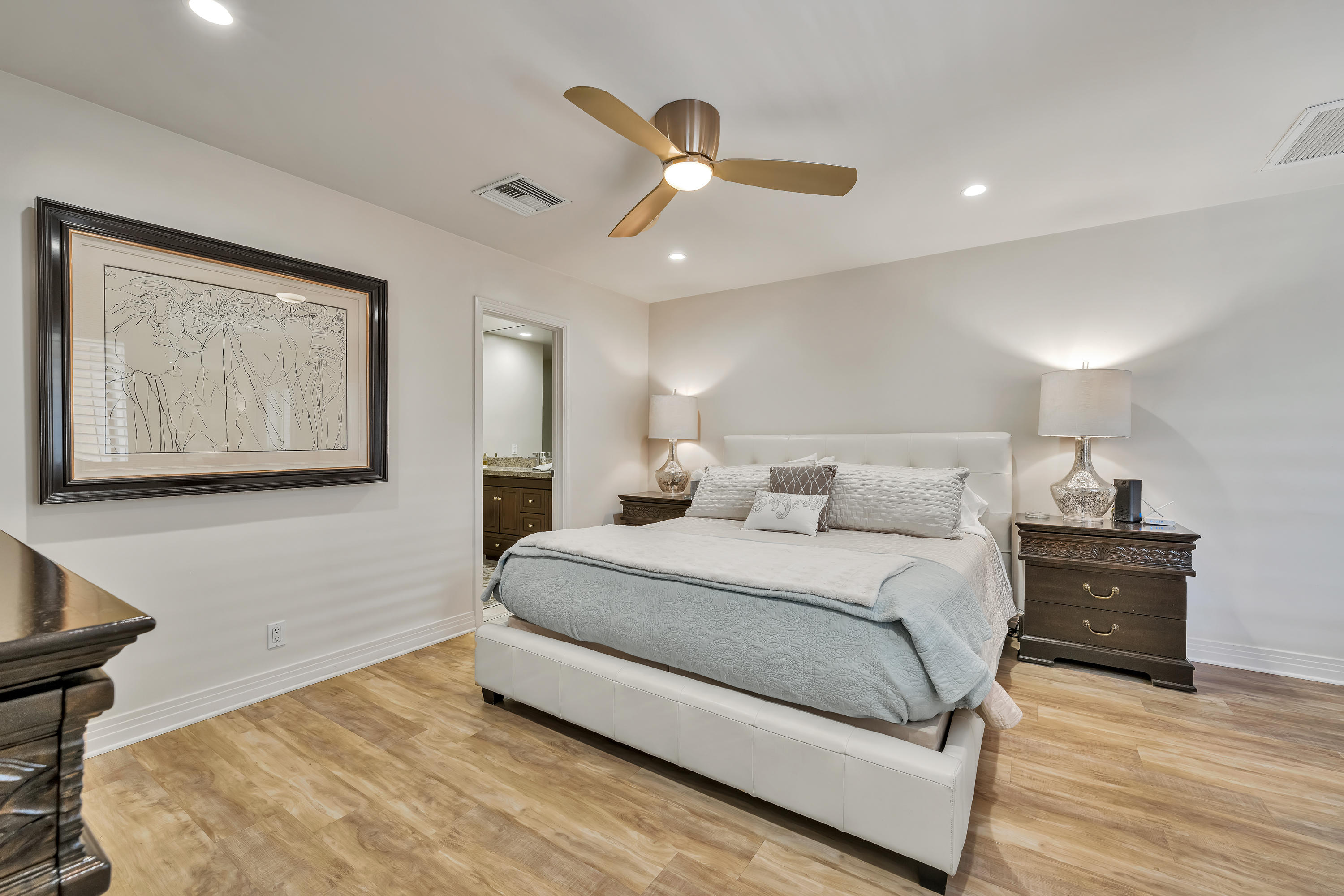 73005 Haystack Road Palm Desert, CA 92260 - Photo 26 of 45 a spacious bedroom with a large bed and a chandelier