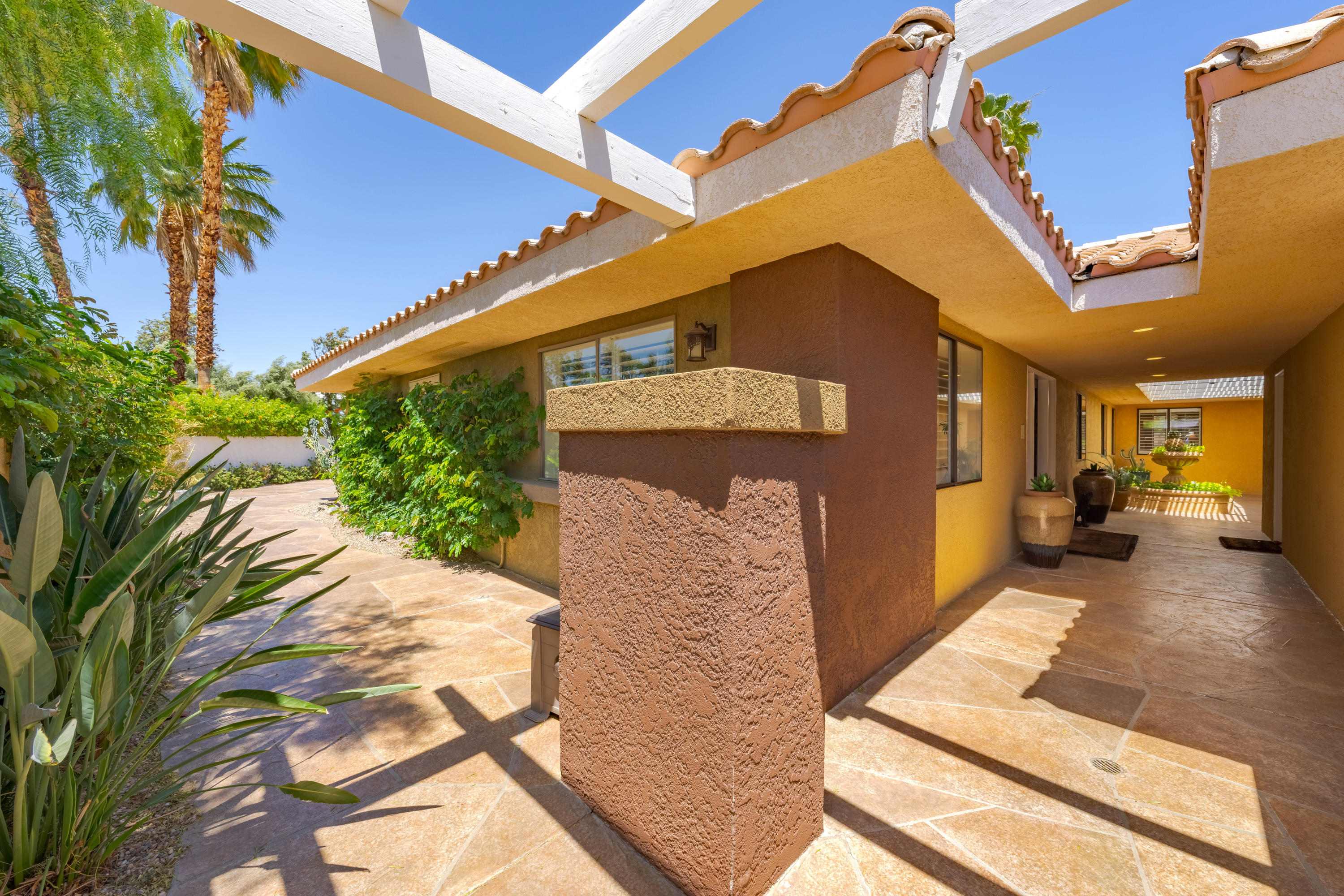 73005 Haystack Road Palm Desert, CA 92260 - Photo 4 of 45 a front view of a house with a yard
