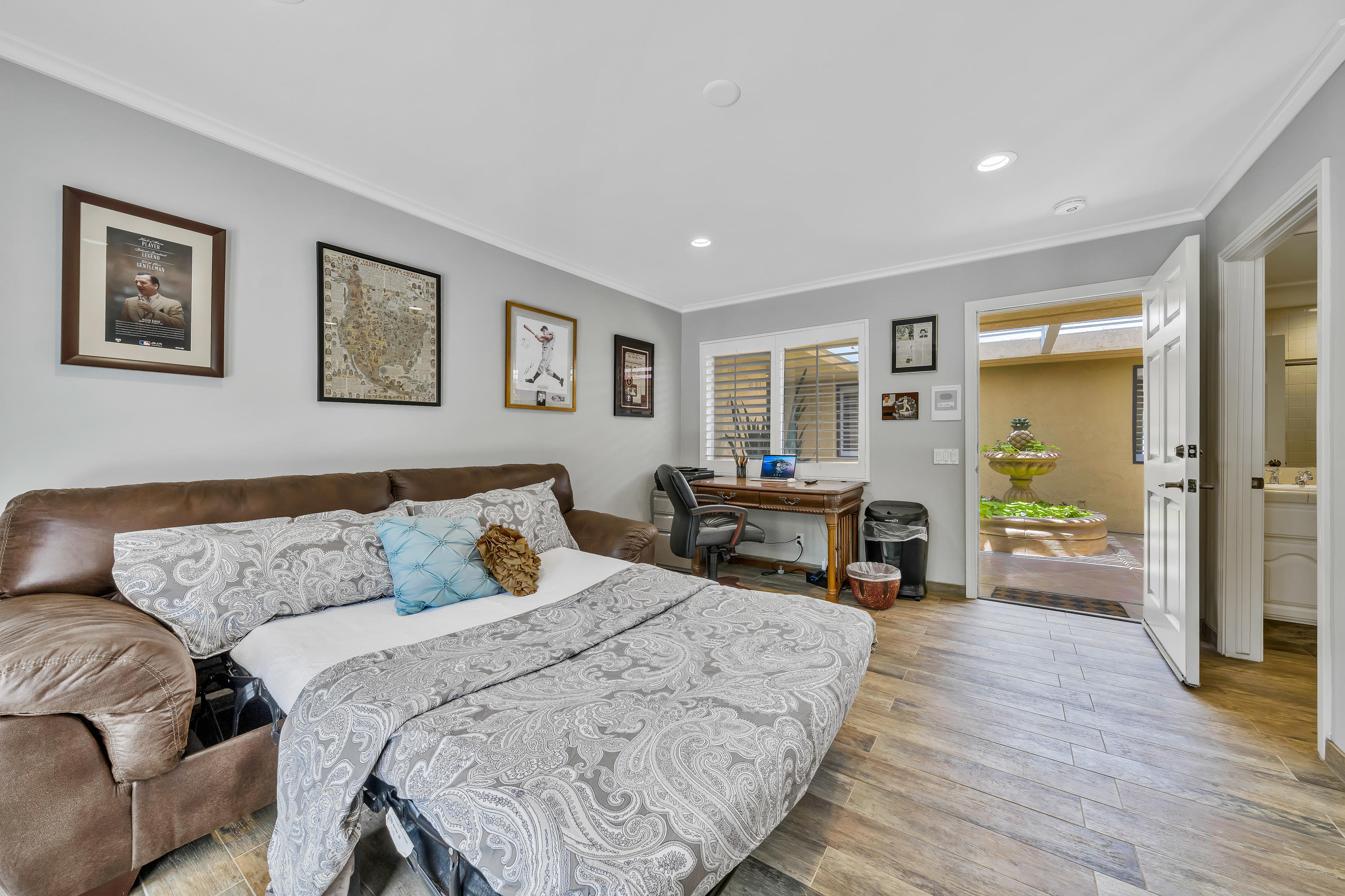 73005 Haystack Road Palm Desert, CA 92260 - Photo 36 of 45 a spacious bedroom with a bed a table and a flat screen tv