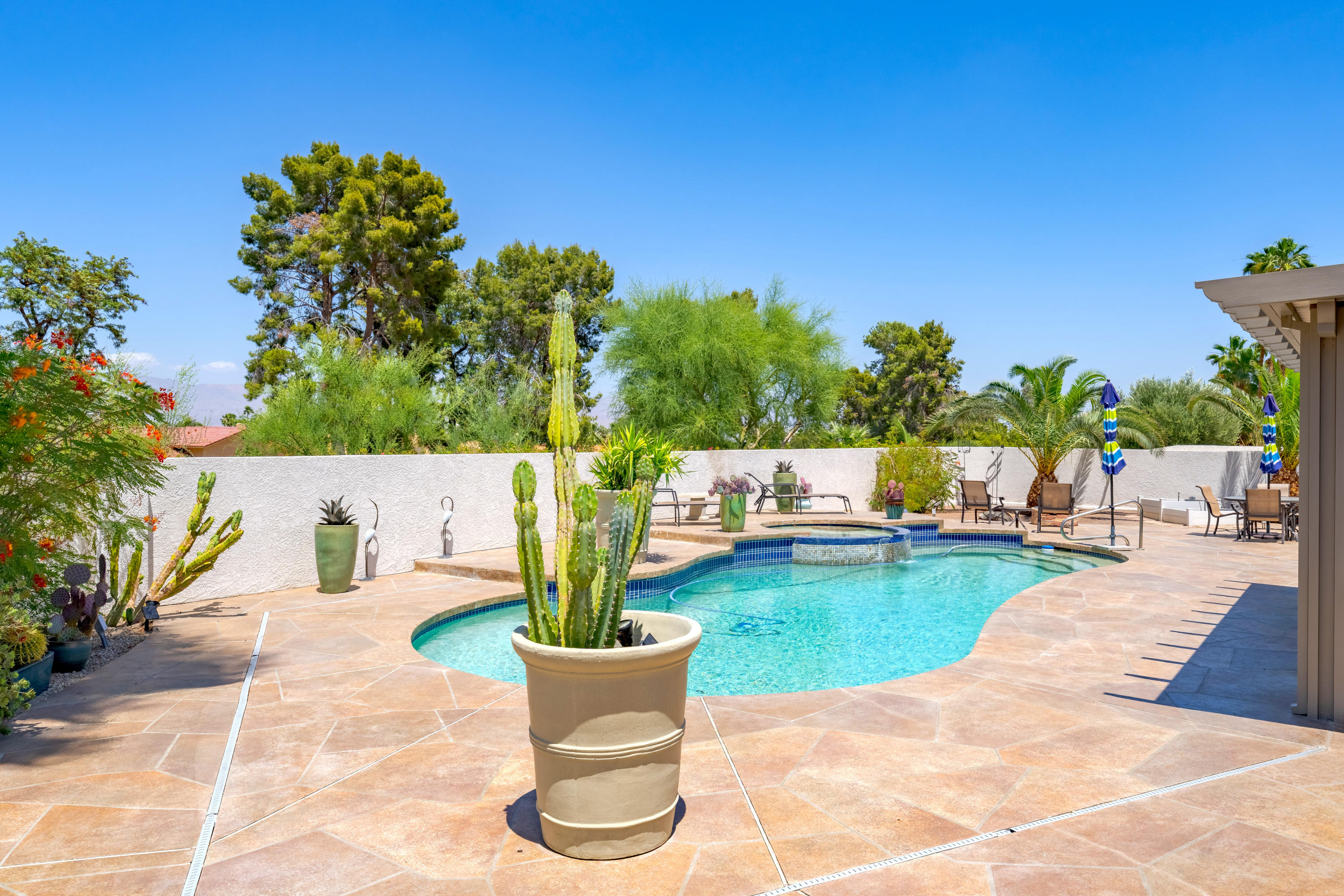 73005 Haystack Road Palm Desert, CA 92260 - Photo 40 of 45 a view of a swimming pool with a patio