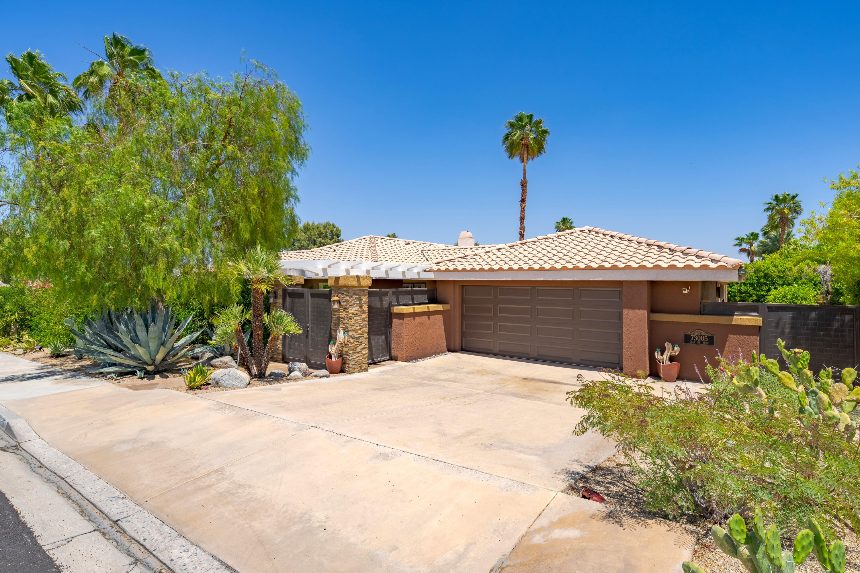 73005 Haystack Road Palm Desert, CA 92260 - Photo 5 of 45 a front view of a house with yard