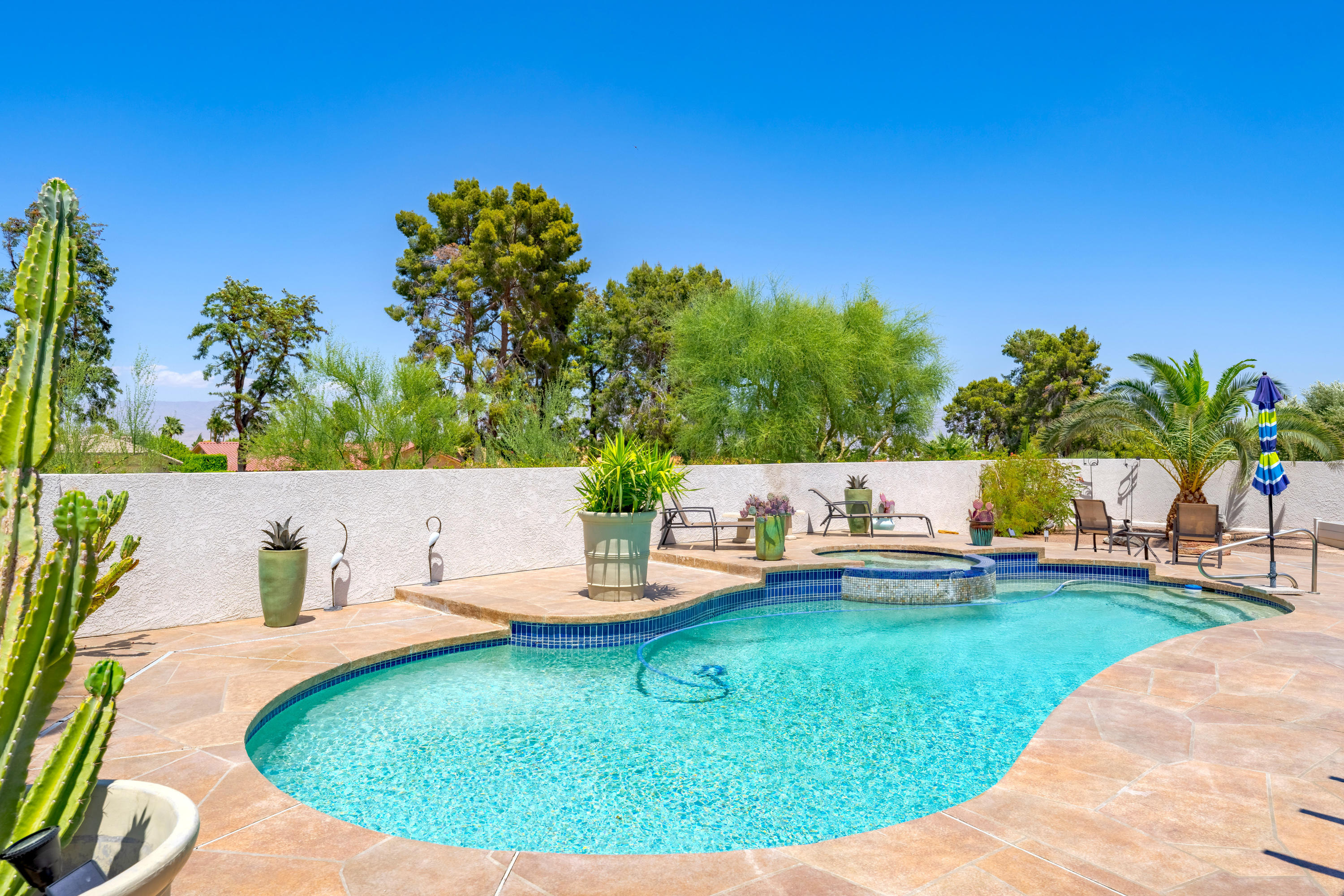 73005 Haystack Road Palm Desert, CA 92260 - Photo 41 of 45 a view of a swimming pool with a patio