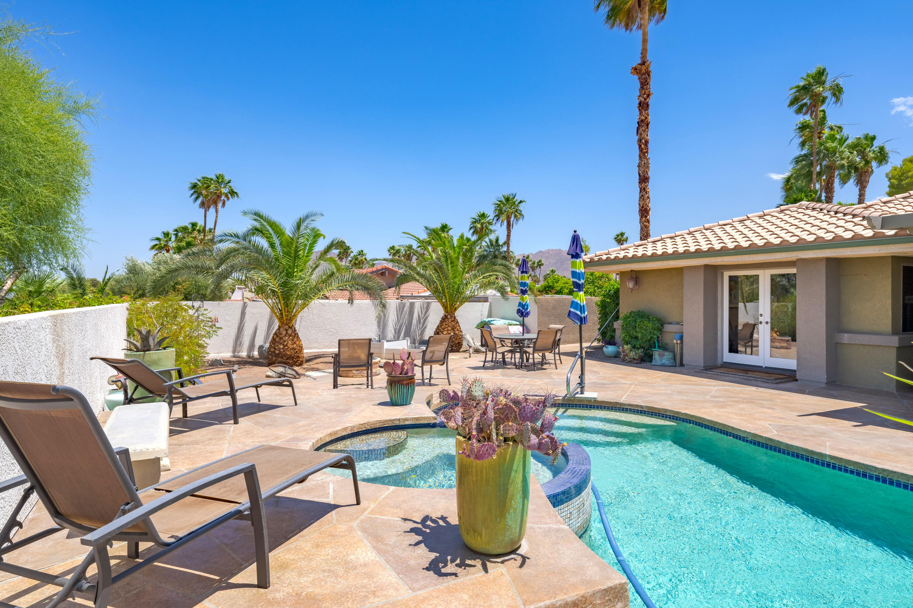 73005 Haystack Road Palm Desert, CA 92260 - Photo 43 of 45 a view of a house with backyard sitting area and swimming pool