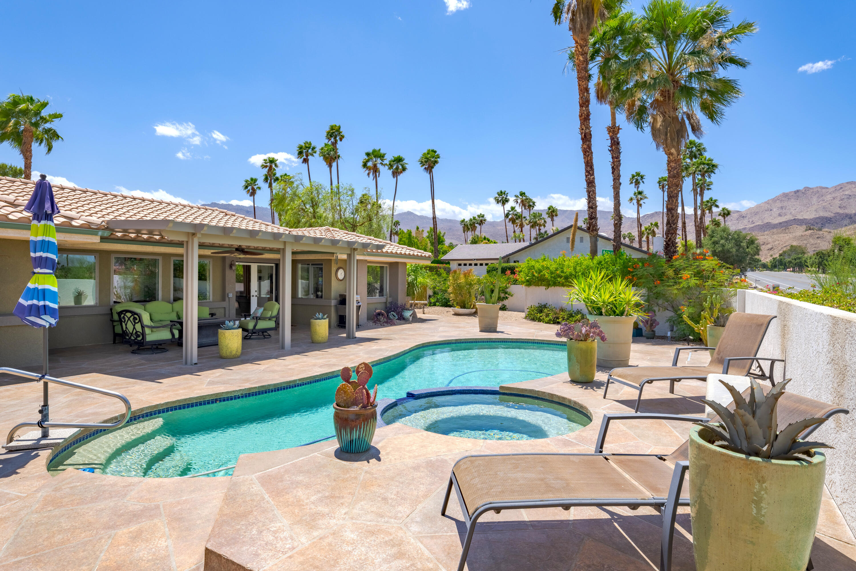 73005 Haystack Road Palm Desert, CA 92260 - Photo 44 of 45 a view of a patio with table and chairs potted plants with palm trees