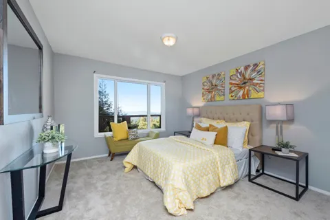 a bedroom with a bed and a couch