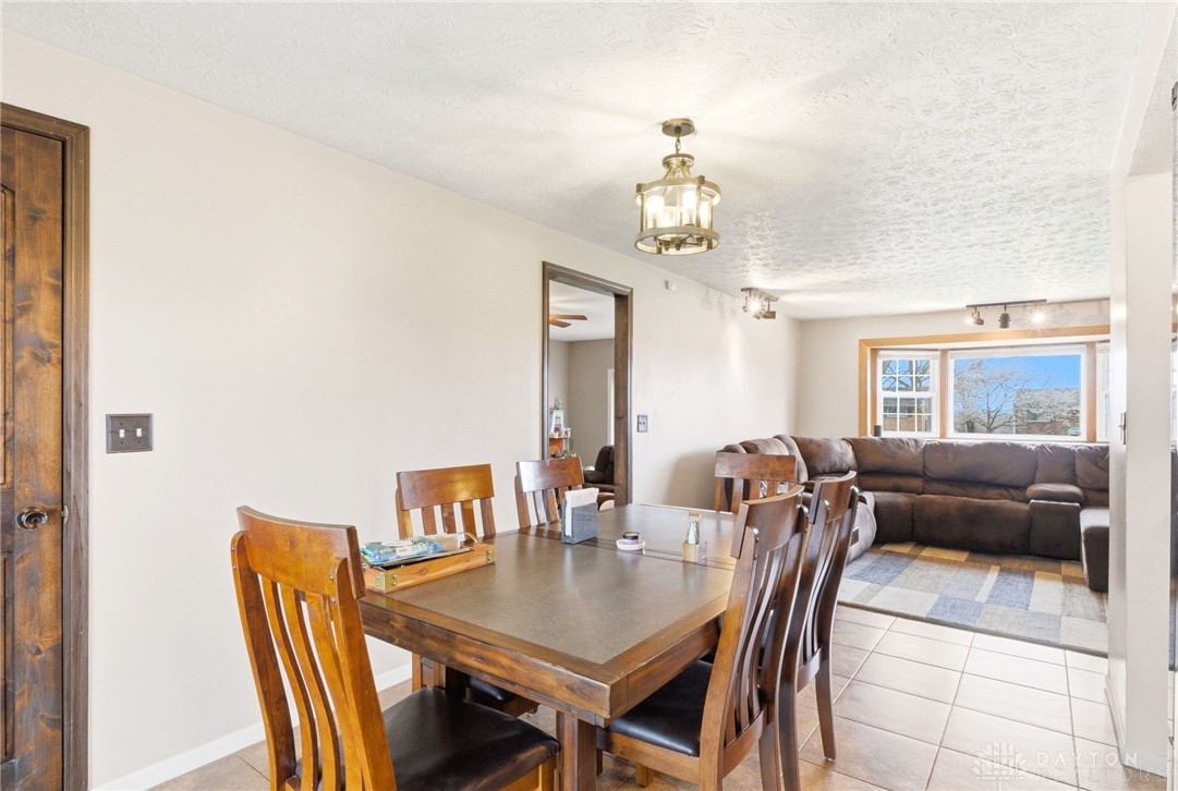 5171 Fishburg Road Dayton, OH 45424 - Photo 12 of 35 This inviting dining area seamlessly connects to a cozy living space, perfect for gatherings.