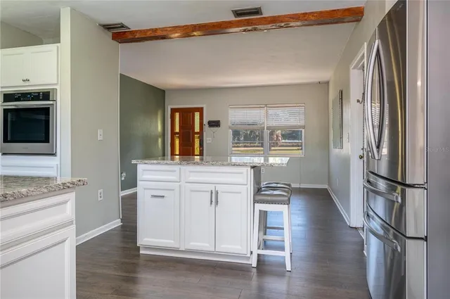 a kitchen with stainless steel appliances a refrigerator and a stove top oven