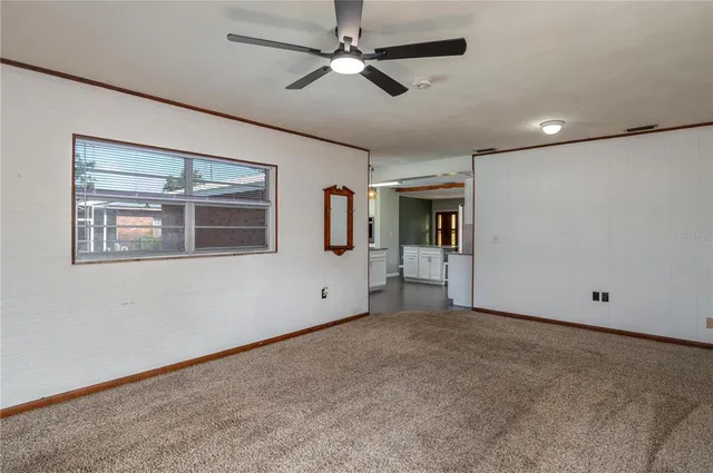 a view of empty room with ceiling fan
