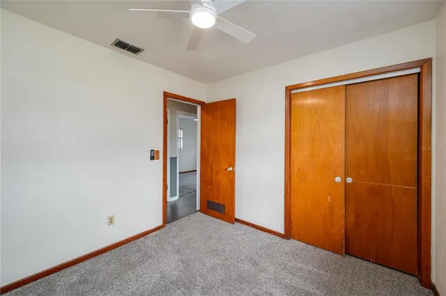 an empty room with closet area