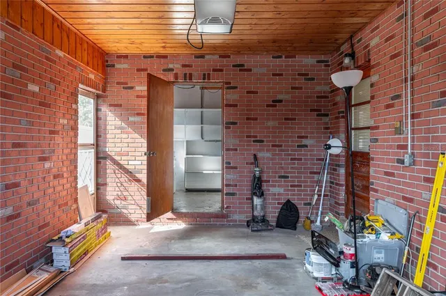 a brick building with a window and a fire pit