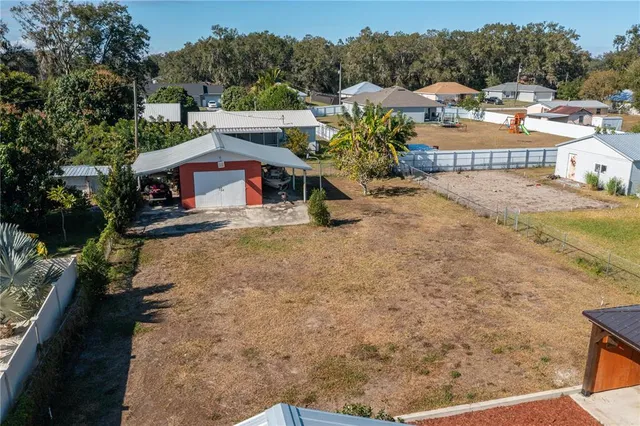 a view of a house with a yard and sitting area