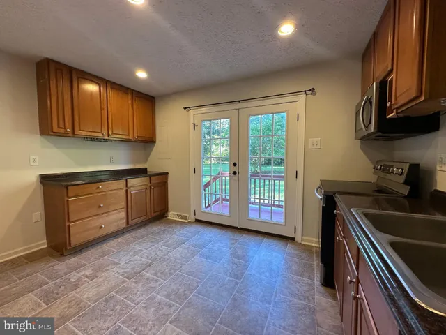a kitchen that has a sink and a stove