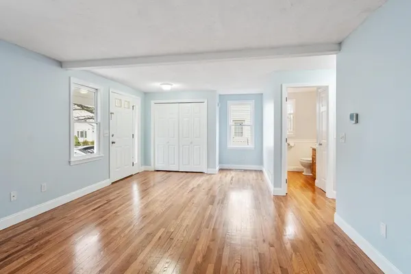 a view of empty room with wooden floor
