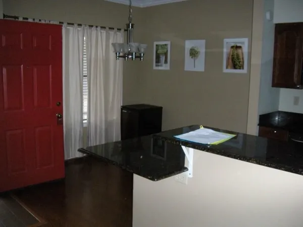a kitchen with a refrigerator and a stove
