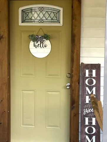 a view of a door and a kitchen